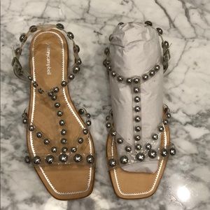 Jeffrey Campbell clear sandals with silver studs.